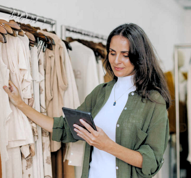 clothing owner using tablet to check stock levels