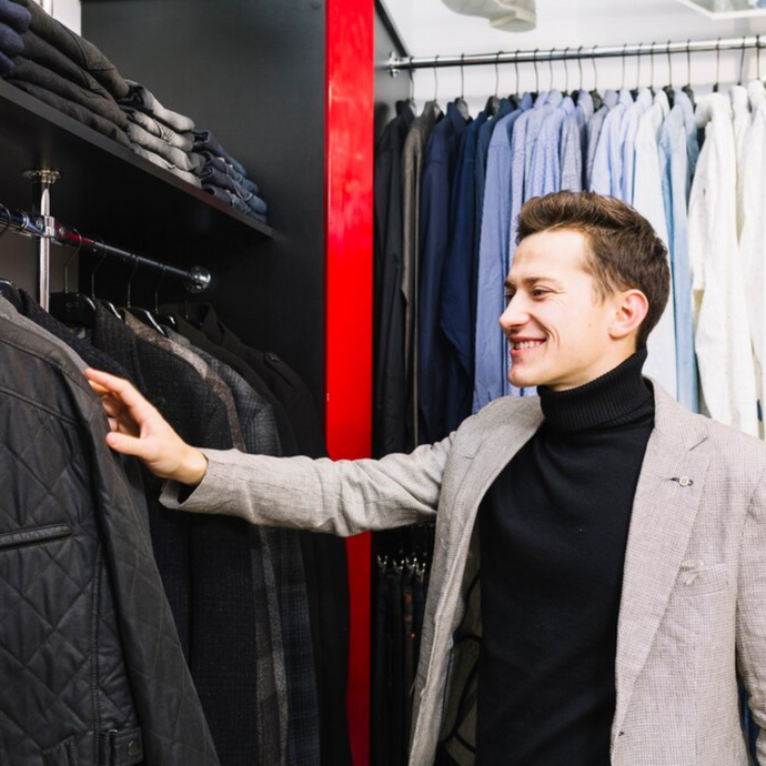 A male customer is selecting clothes in the store