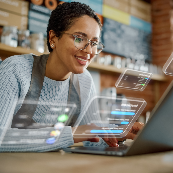 A female employee is using a laptop to manage replenishment tasks