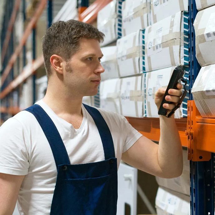 An employee is using an mPOS device to conduct a stock take