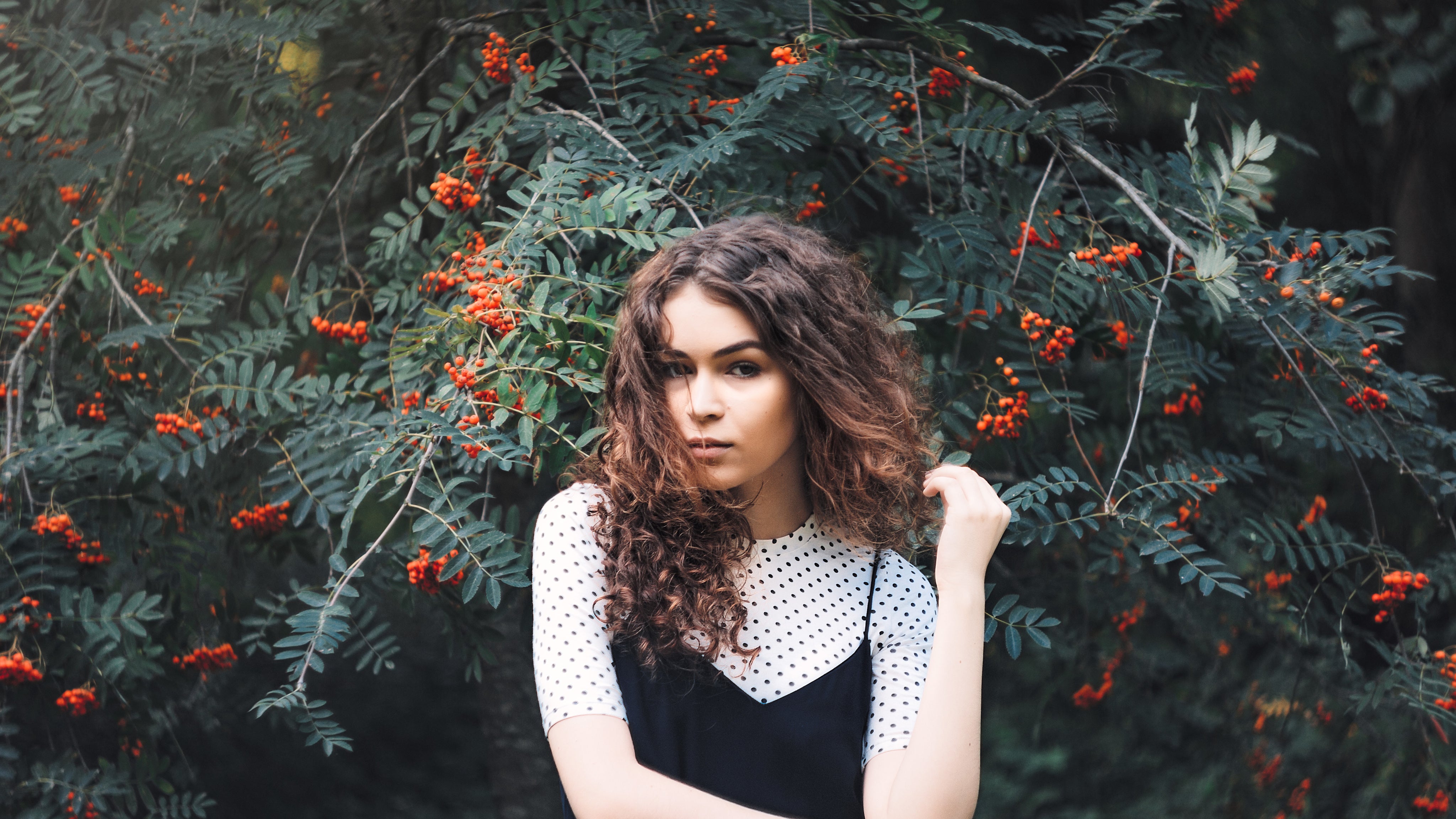 woman infront of tree with berries